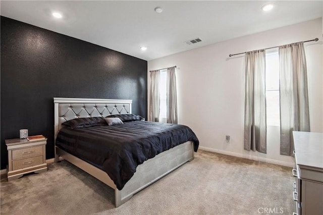 carpeted bedroom featuring multiple windows