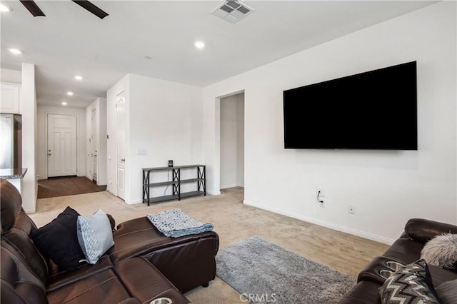 carpeted living room featuring ceiling fan