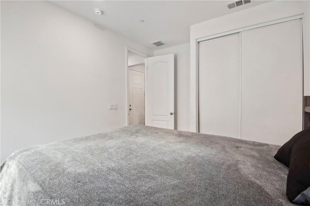 unfurnished bedroom with carpet floors and a closet