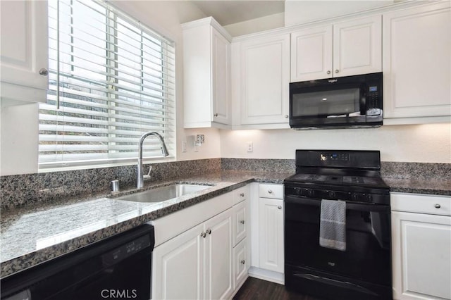 kitchen featuring white cabinets, dark stone countertops, sink, and black appliances