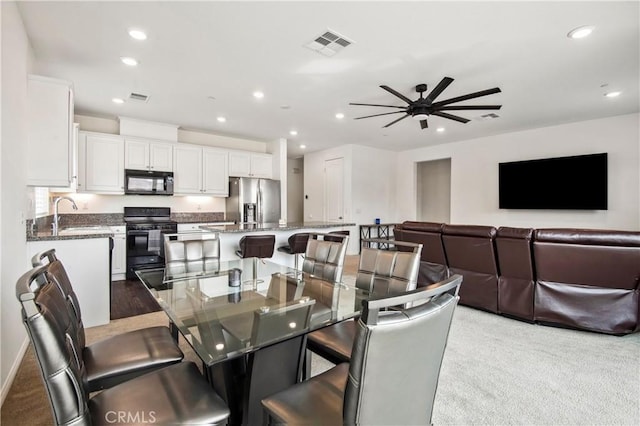 dining area with sink and ceiling fan