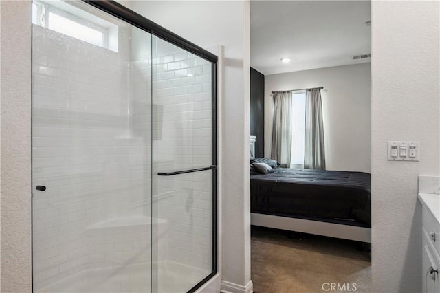 bathroom featuring walk in shower and vanity