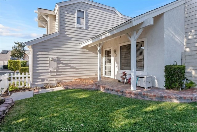 rear view of house with a yard