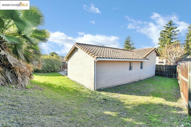 view of home's exterior featuring a yard