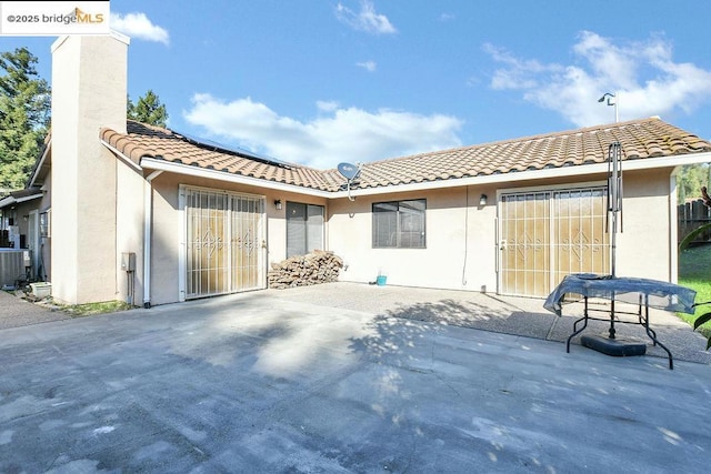 rear view of house featuring a patio and central air condition unit