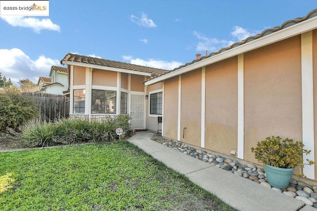 entrance to property with a yard