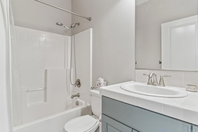 full bathroom with bathing tub / shower combination, vanity, and toilet