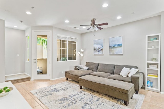 tiled living room with ceiling fan