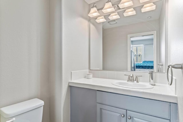 bathroom with toilet and vanity