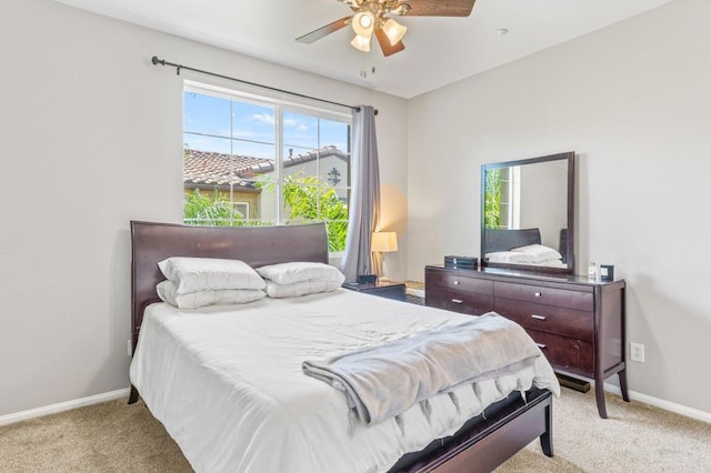 bedroom with multiple windows, baseboards, and light carpet