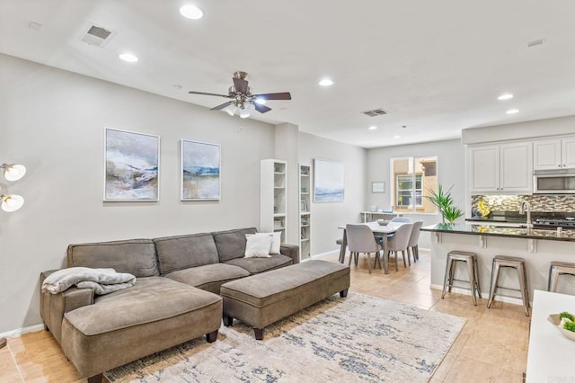 living room featuring light tile patterned floors, visible vents, recessed lighting, and a ceiling fan