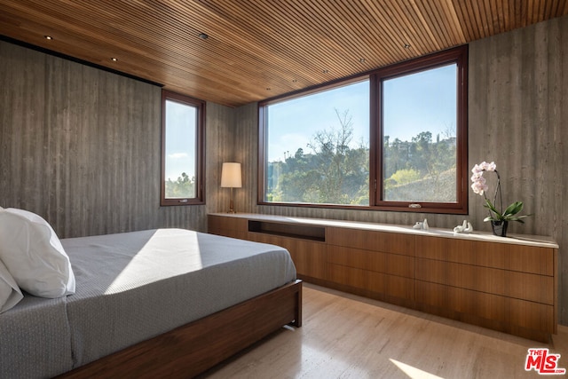 bedroom featuring light hardwood / wood-style flooring and wooden ceiling