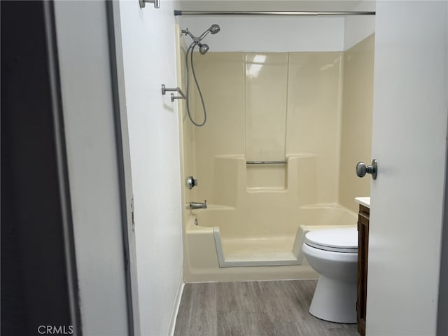 bathroom with toilet, wood finished floors, and vanity