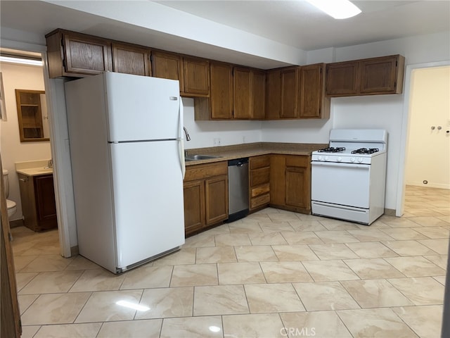 kitchen with white appliances and a sink