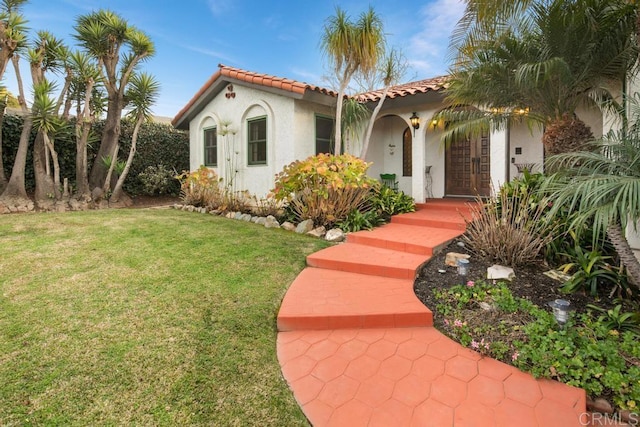 mediterranean / spanish house with a front yard