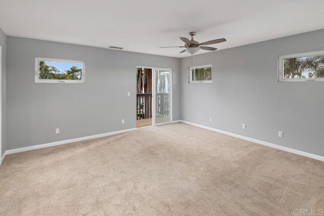 unfurnished room featuring visible vents, ceiling fan, light carpet, and baseboards