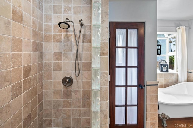 full bath with a tile shower