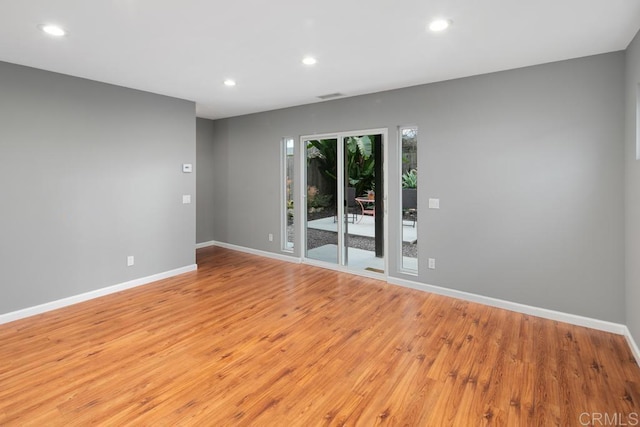 unfurnished room with baseboards and recessed lighting