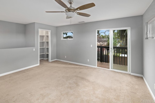 unfurnished room with visible vents, baseboards, a ceiling fan, and light colored carpet