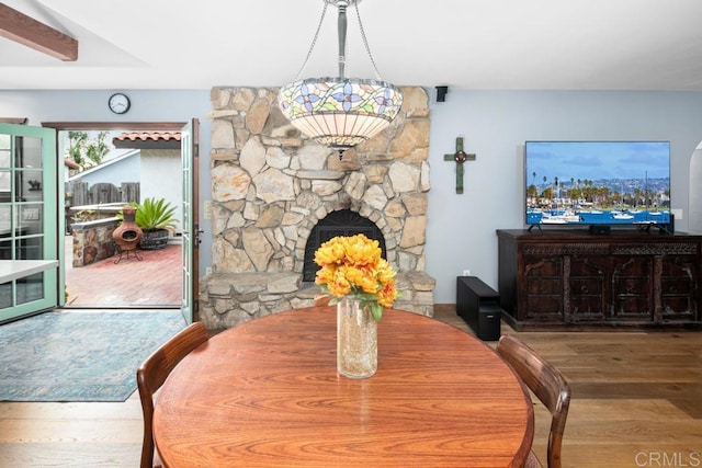 dining area with a fireplace and wood finished floors