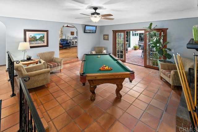 recreation room with billiards, arched walkways, ceiling fan, and tile patterned flooring