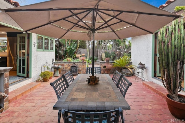 view of patio featuring outdoor dining area and fence