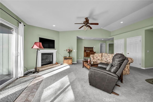 carpeted living room featuring lofted ceiling, recessed lighting, a glass covered fireplace, and baseboards