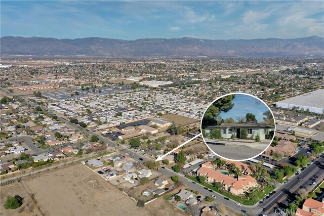 birds eye view of property with a mountain view