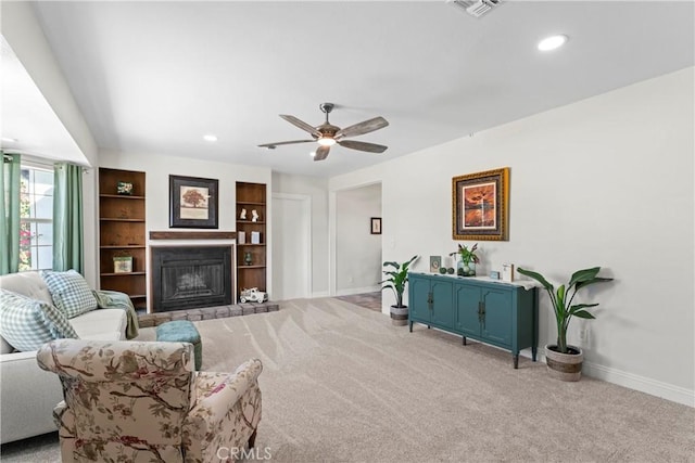 carpeted living room with ceiling fan