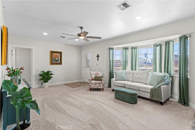 living room with carpet floors and ceiling fan