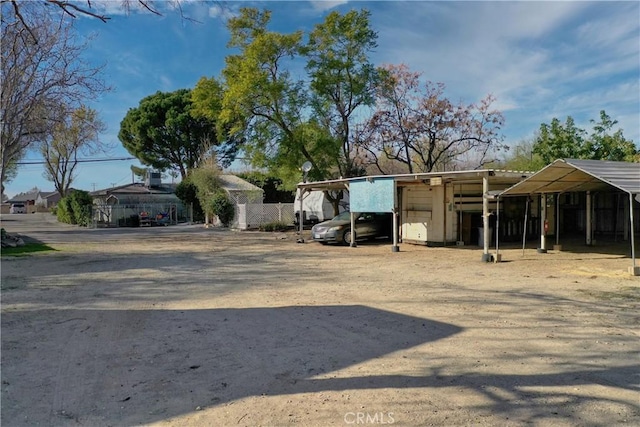 view of yard with fence and a detached carport