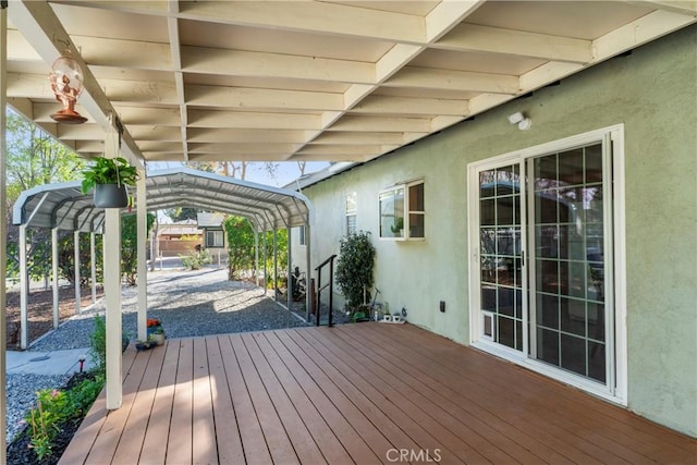 wooden deck featuring a detached carport