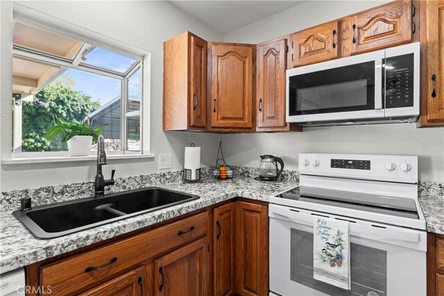 kitchen featuring sink and white appliances