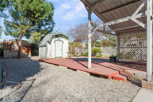 view of yard featuring a shed and a deck