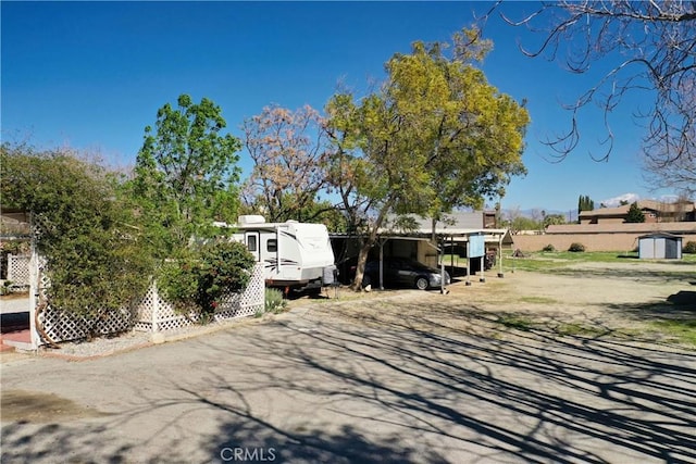 view of front facade featuring a carport and an outdoor structure