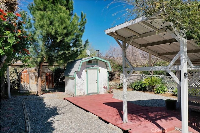 exterior space with a storage shed, an outdoor structure, and fence