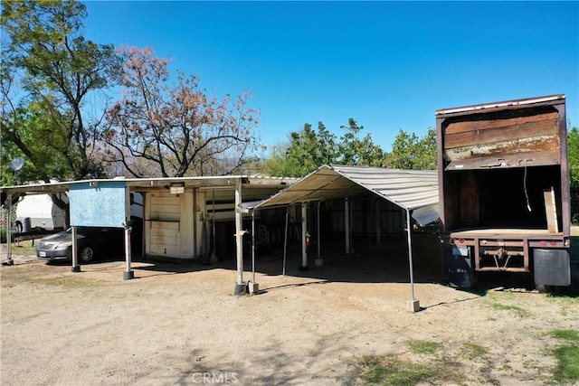 view of outbuilding with a detached carport