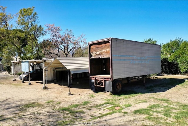 view of outdoor structure featuring a carport and an outdoor structure