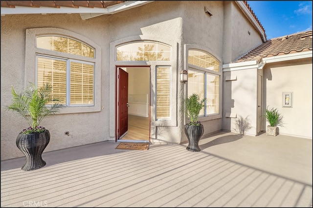 doorway to property with a patio area