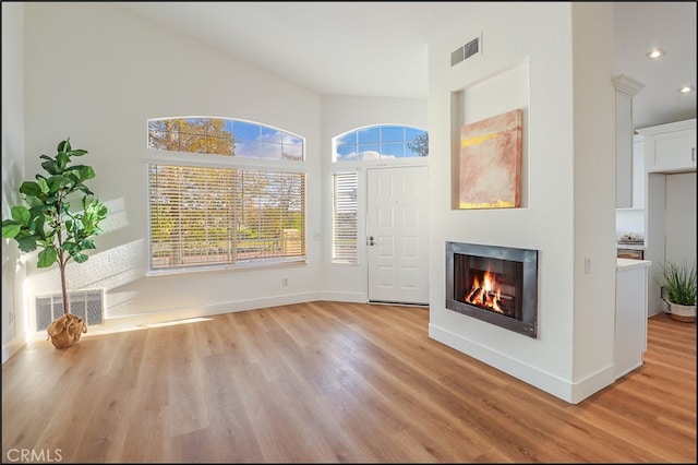 entrance foyer featuring light hardwood / wood-style flooring and a high ceiling