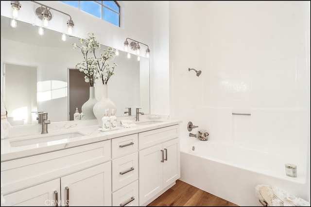 bathroom featuring vanity, a bathtub, and hardwood / wood-style floors