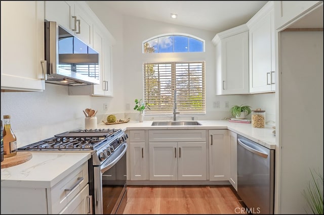 kitchen featuring white cabinetry, appliances with stainless steel finishes, sink, and plenty of natural light