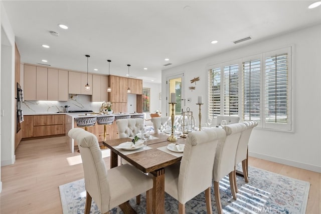 dining space featuring light wood-type flooring