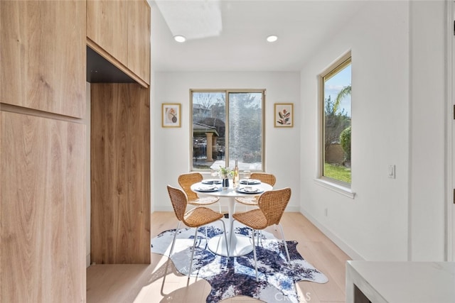 dining space featuring a healthy amount of sunlight and light hardwood / wood-style floors