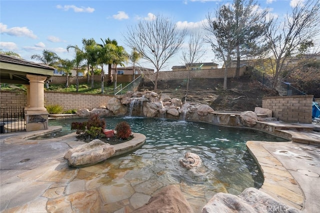 view of swimming pool featuring pool water feature