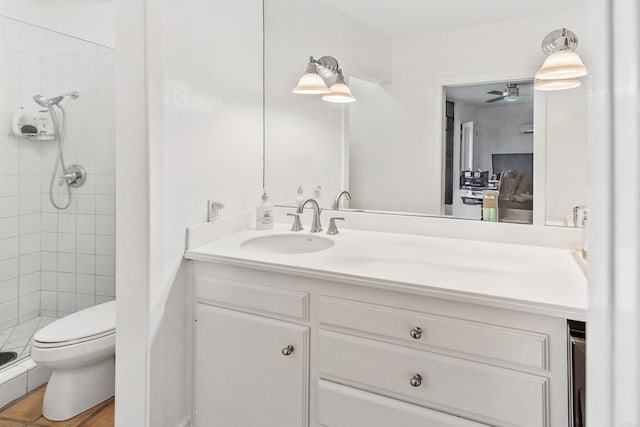 bathroom featuring vanity, an enclosed shower, and toilet