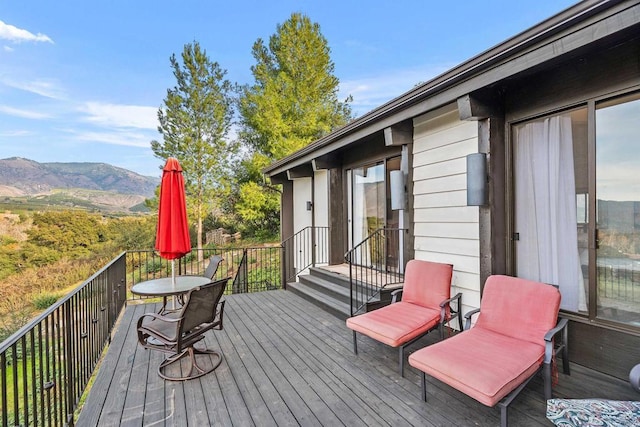 wooden deck with a mountain view