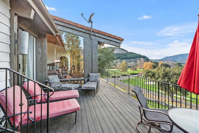 wooden deck with a mountain view