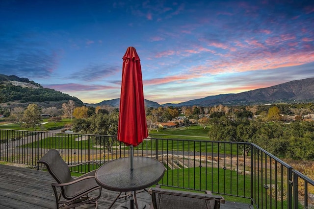 exterior space featuring a mountain view and a lawn