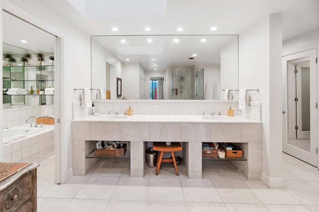 bathroom featuring tasteful backsplash, vanity, separate shower and tub, and tile patterned flooring